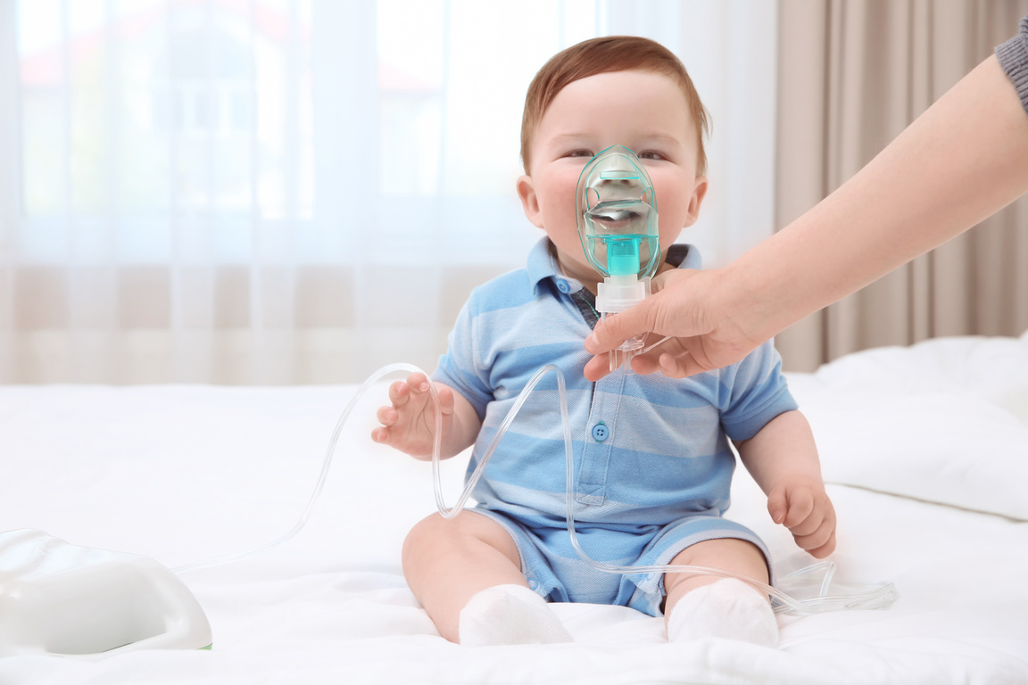  Woman with Little Baby and Nebulizer Indoors